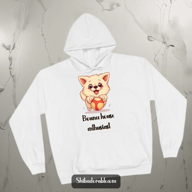 Funny Hoodie: A fluffy dog with exaggerated big eyes joyfully chasing a bouncing ball, expressing boundless enthusiasm.