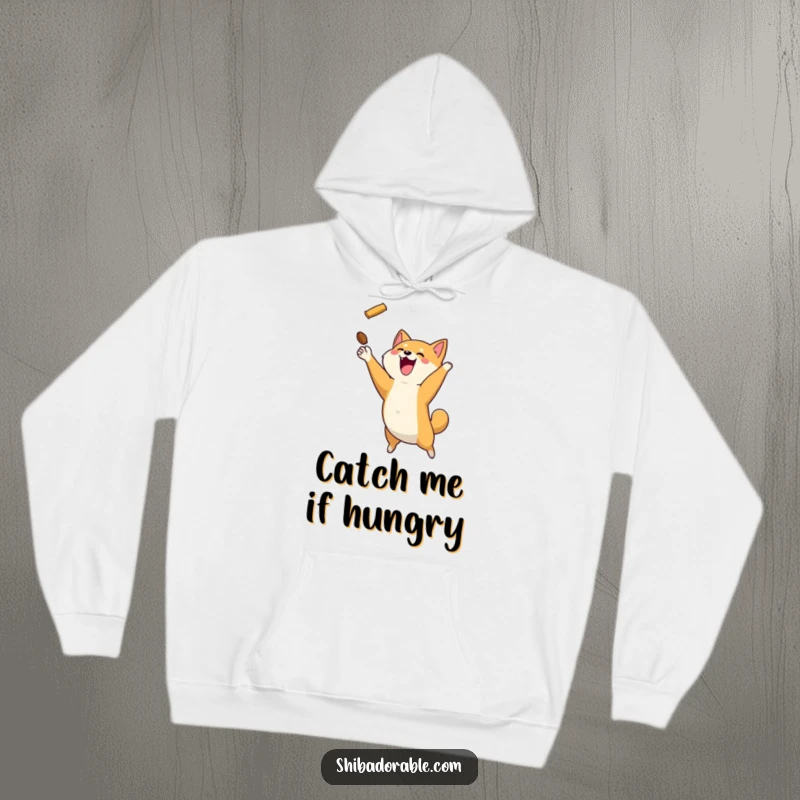 Funny Shiba Inu dog mid-leap, catching a flying treat, printed on a soft and warm hoodie.