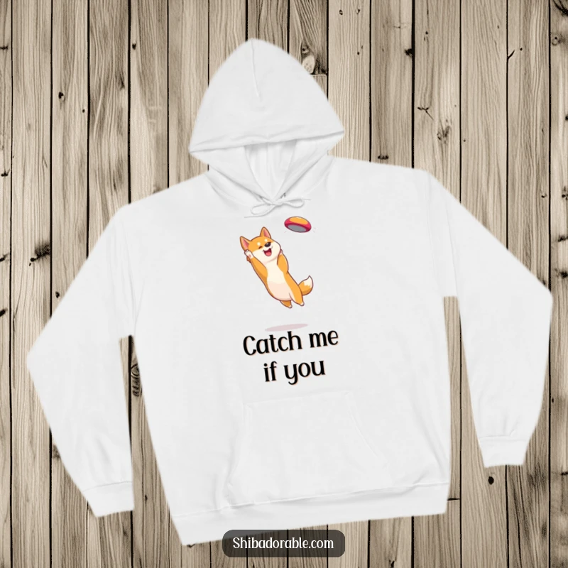 Funny Shiba Inu Hoodie: Warm sweatshirt depicting a focused Shiba Inu leaping high to snatch a brightly colored frisbee.