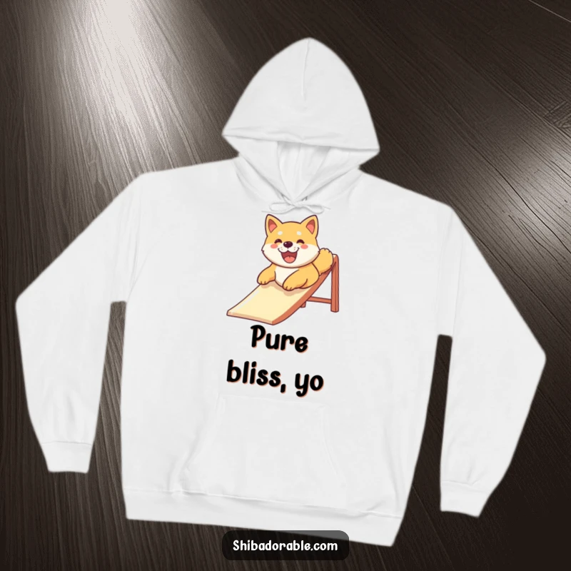 Funny Shiba Inu dog smiling widely while sliding down a playground slide, printed on a warm hoodie for ultimate comfort and humor.