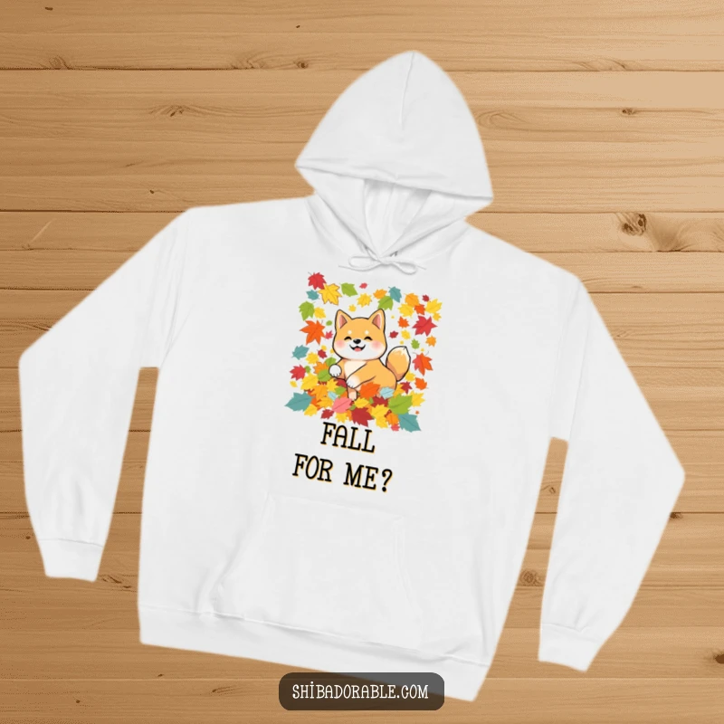 Funny Shiba Inu dog tumbling in colorful autumn leaves, printed on a warm hoodie, ideal for cozy fall vibes and dog lovers.