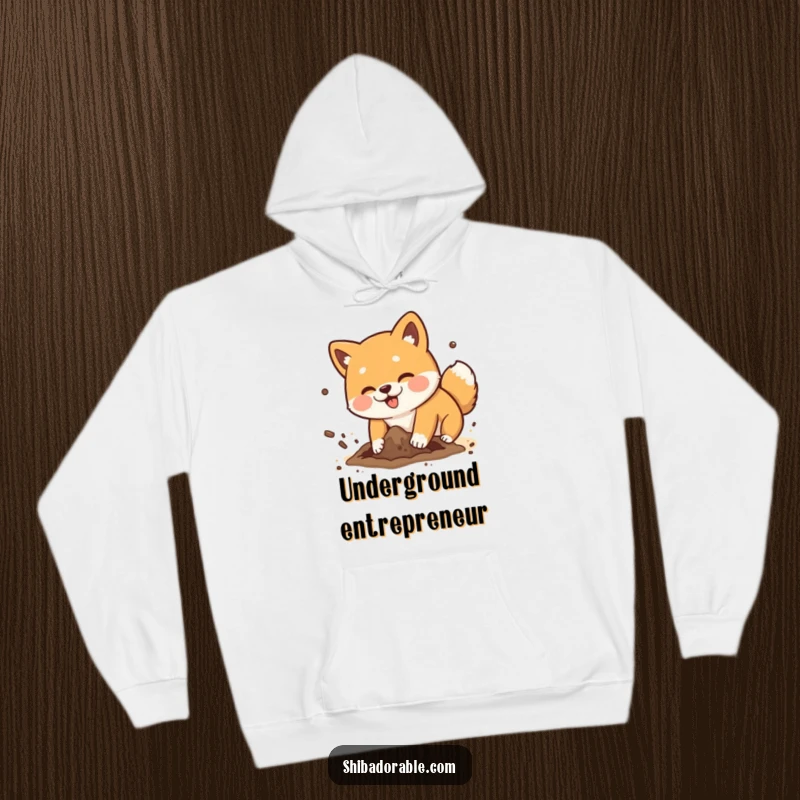 Funny Shiba Inu dog playfully digging a hole with dirt flying comically, a warm and humorous hooded sweatshirt.