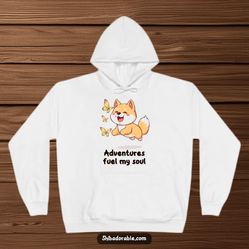 Funny Shiba Inu hoodie showcasing a happy dog leaping playfully in pursuit of a delicate, shimmering butterfly, full of energy.