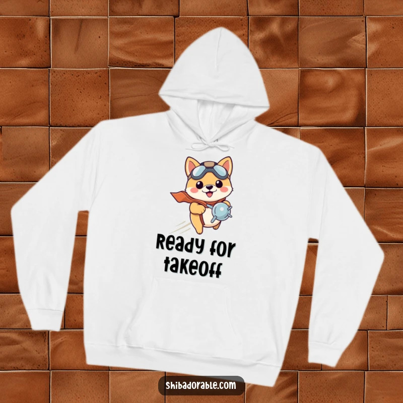 Funny Shiba Inu puppy sporting a tiny pilot hat, zooming with a propeller, embodying adventurous spirit. A comfortable hoodie.