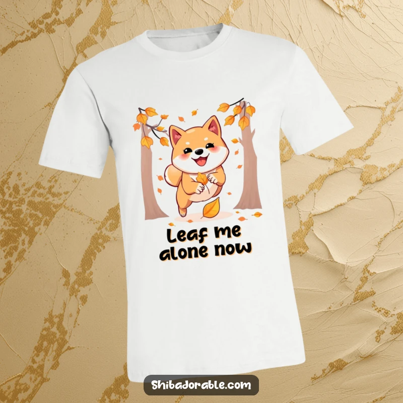 Funny t-shirt showcasing an agile Shiba Inu mid-pounce onto a vibrant falling autumn leaf, embodying playful energy.