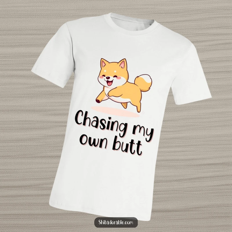 Funny Shiba Inu dog captured mid-spin, playfully chasing its tail on a comfortable t-shirt.