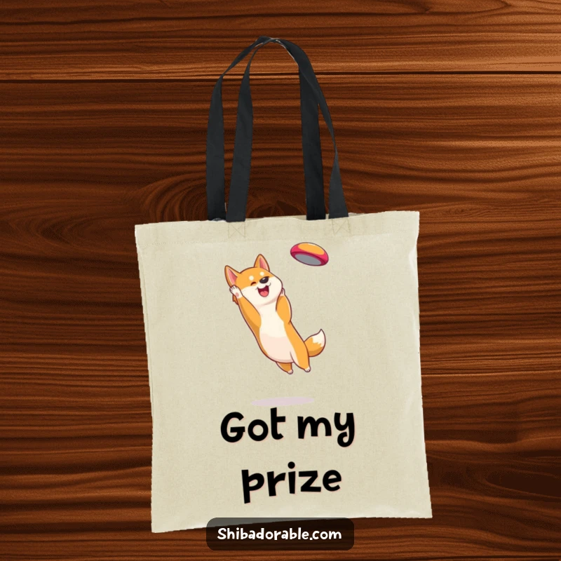 Funny Shiba Inu Tote Bag: Durable carry-all showcasing an energetic dog catching a frisbee in mid-air with excitement.